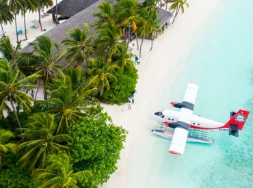 float plane parked by a Hawaiian beach
