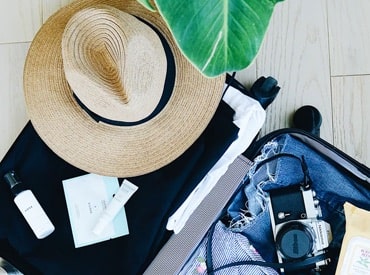 Hawaiian vacation gear in open suitcase